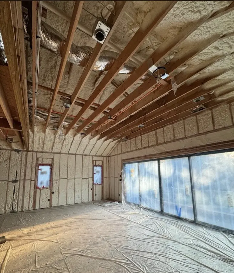 Interior walls and ceiling insulated with spray foam during new construction in West Goshen